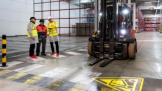 Konsultaatio usean henkilön kesken tehdashallissa. Konsultaatio usean henkilön kesken tehdashallissa.
